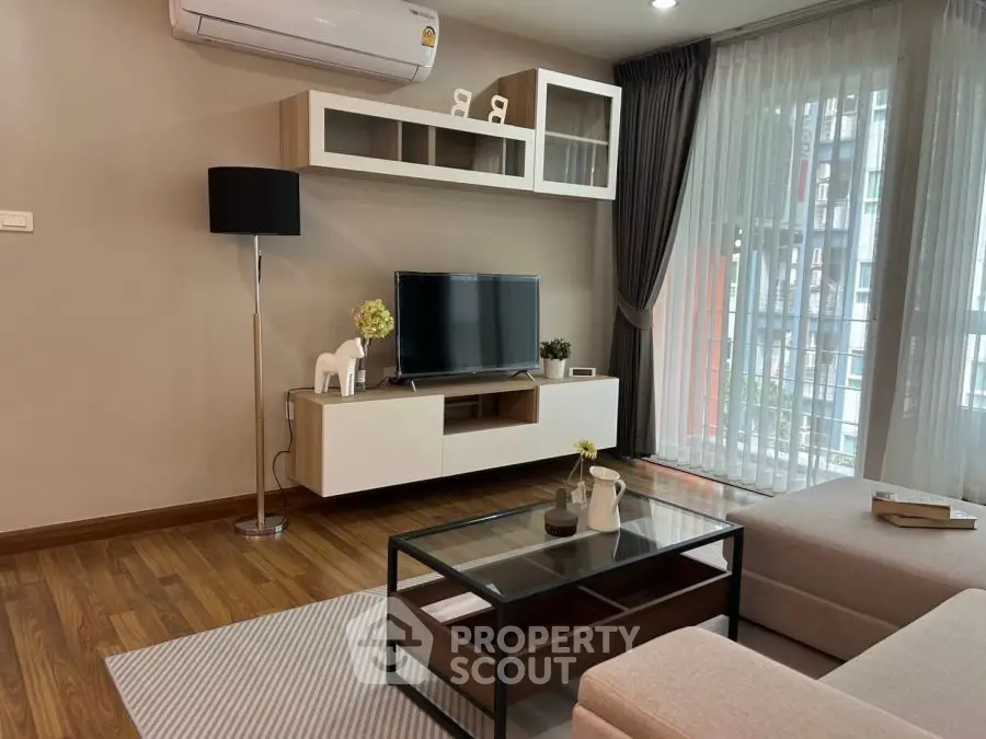 Modern living room with sleek furniture and large window view
