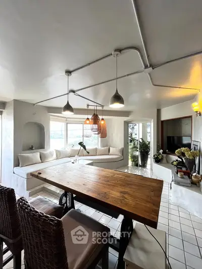Spacious living room with modern decor and large windows offering natural light.