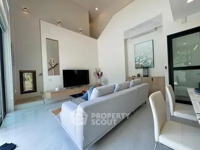 Modern living room with high ceiling and stylish decor