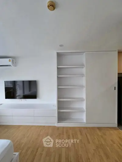Modern living room with built-in shelving and sleek TV setup