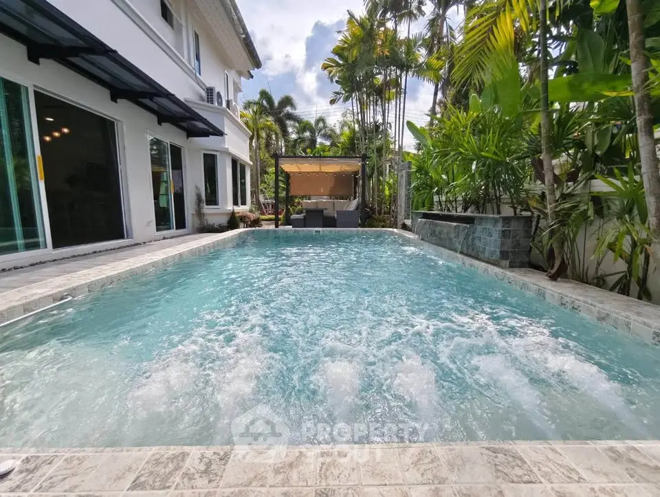 Luxurious private pool with lush tropical garden and elegant seating area