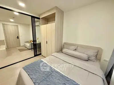 Modern bedroom with sliding glass doors and cozy decor in a stylish apartment.