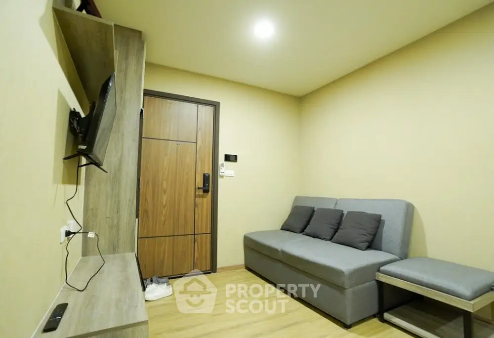 Cozy living room with modern sofa and wall-mounted TV in a stylish apartment
