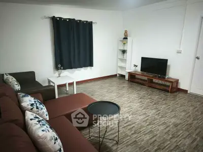 Spacious living room with modern decor and comfortable seating