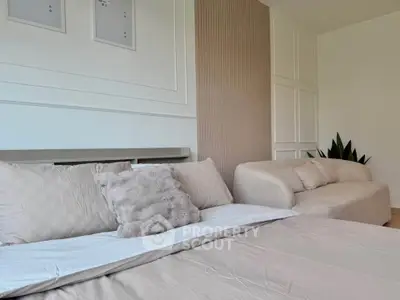 Luxurious bedroom with elegant decor and cozy seating area