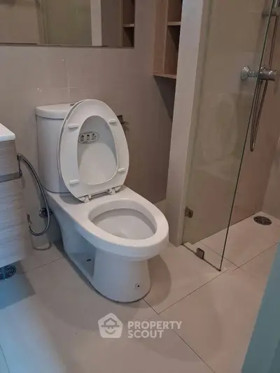 Modern bathroom with sleek design and glass shower enclosure, perfect for contemporary living.