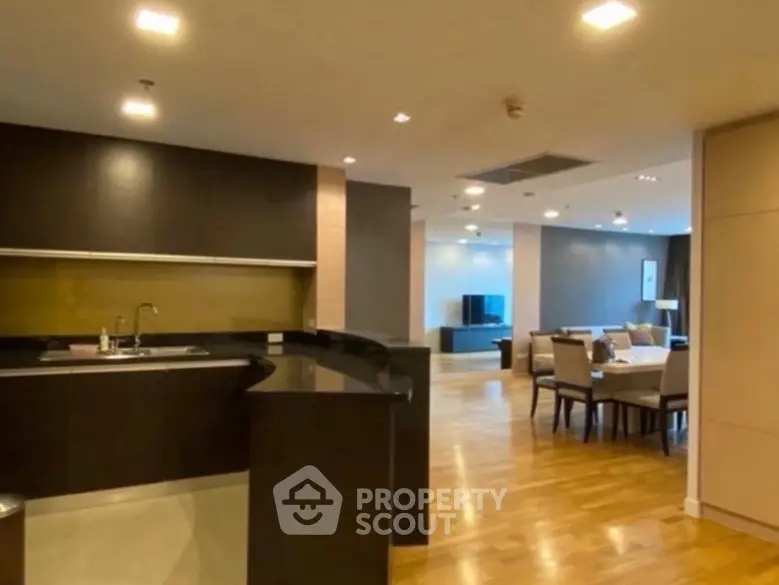 Spacious open-plan kitchen and living area with modern design and hardwood floors.