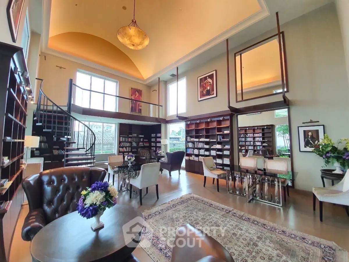 Luxurious library with high ceilings and elegant decor in a modern building.