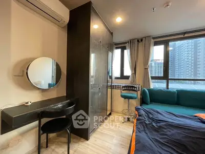 Modern bedroom with large windows, stylish furniture, and city view, perfect for urban living.