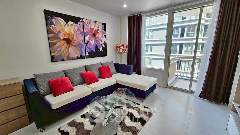 Modern living room with stylish decor and balcony view in urban apartment.
