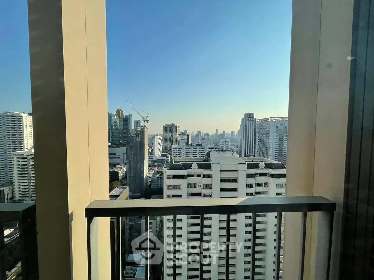 Stunning cityscape view from a high-rise balcony in urban setting.
