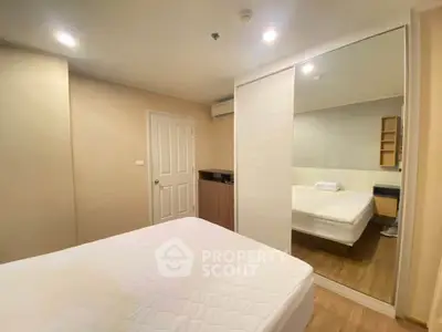 Cozy bedroom with mirrored wardrobe and soft lighting in modern apartment