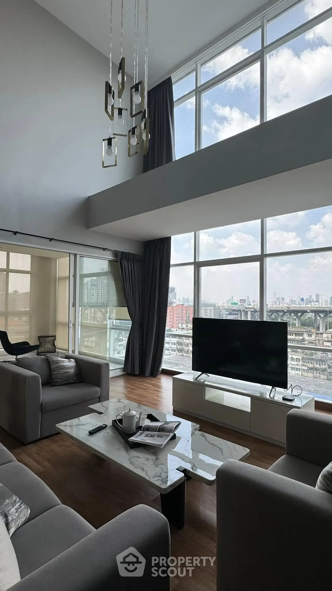 Luxurious modern living room with high ceilings and stunning city view