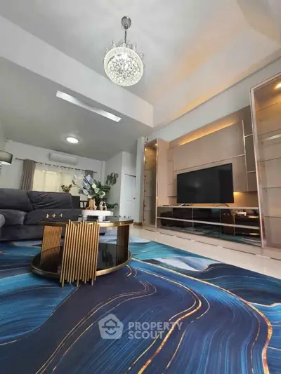 Luxurious living room with modern decor, elegant chandelier, and stylish furniture.