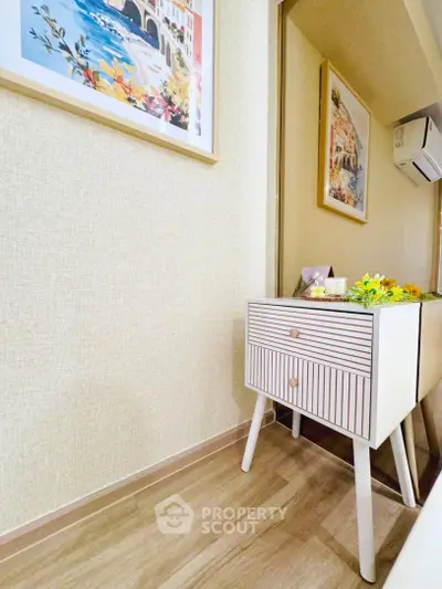 Charming interior with stylish side table and wall art in cozy living space