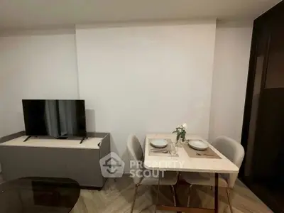 Modern living room with dining area and TV setup, perfect for cozy gatherings.