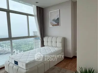 Modern bedroom with large window and scenic view, featuring a stylish bed and contemporary decor.