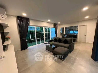 Spacious modern living room with large windows and garden view