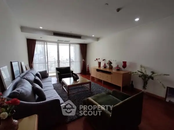 Spacious living room with modern furniture and large windows offering natural light.