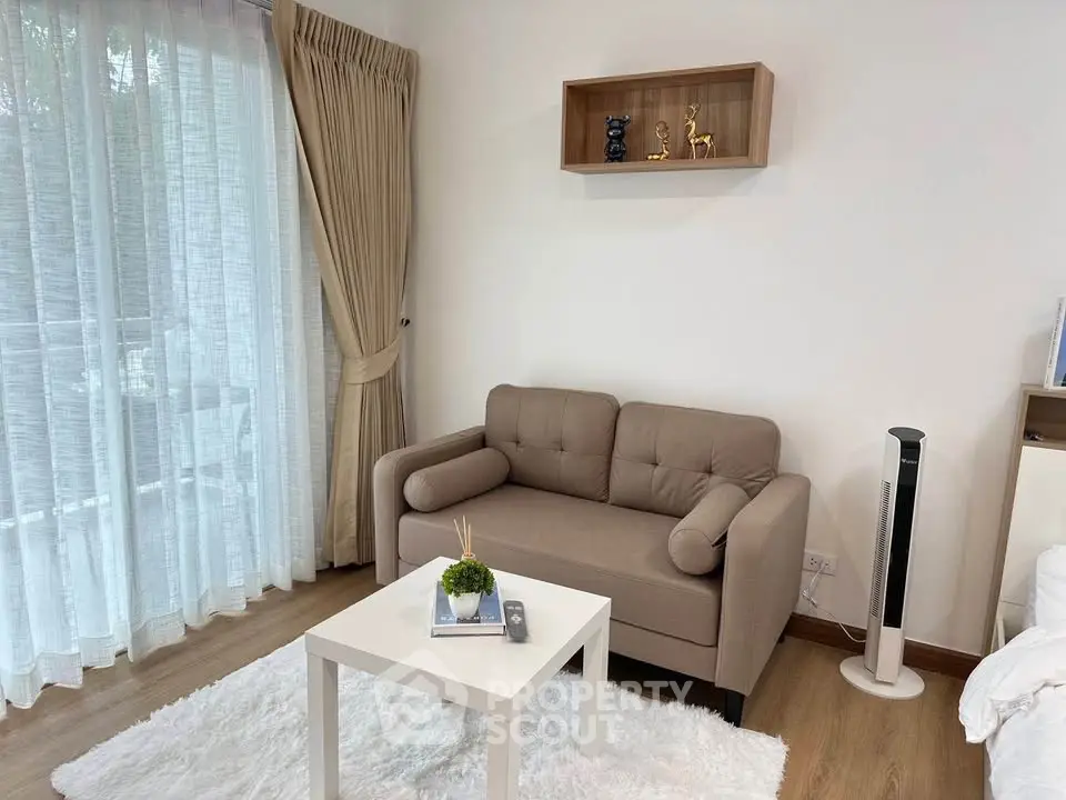 Cozy living room with modern decor, featuring a plush sofa, elegant curtains, and a stylish coffee table.