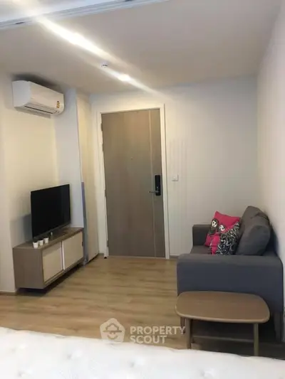 Cozy living room with modern furniture and wooden flooring in a stylish apartment.