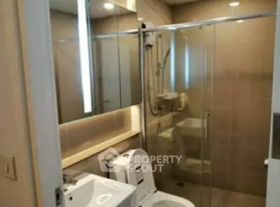 Modern bathroom with glass shower and sleek fixtures