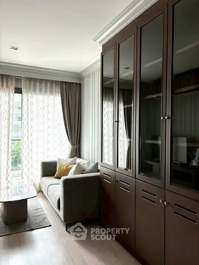 Elegant living room with floor-to-ceiling windows and stylish cabinetry