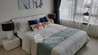 Modern bedroom with stylish decor and city view, featuring a cozy bed and elegant lighting.