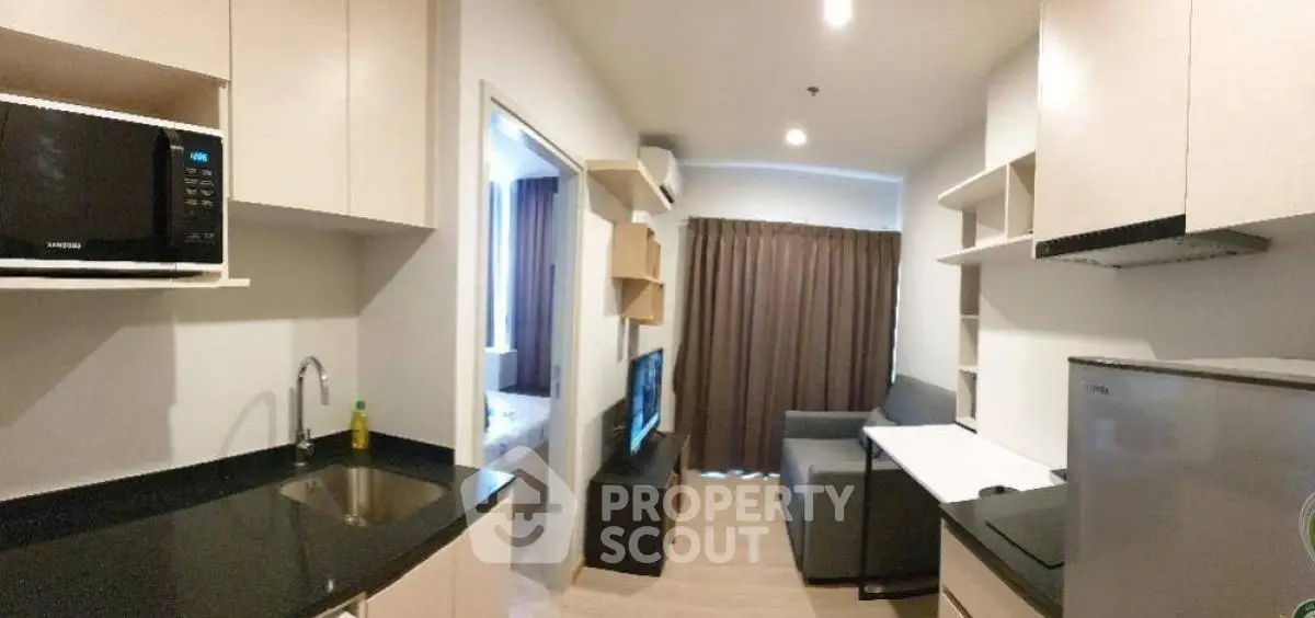 Modern studio apartment with open kitchen layout and cozy living area