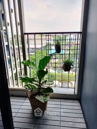 Cozy balcony space with potted plants and a serene view, perfect for relaxation and enjoying the outdoors from the comfort of your home.