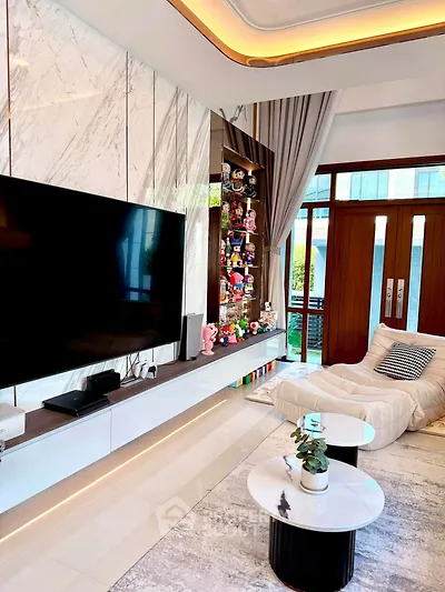Luxurious modern living room with marble accents and large TV, featuring stylish decor and plush seating.