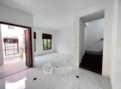 Spacious modern living area with marble flooring and open entrance