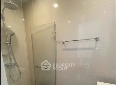 Modern bathroom with glass shower enclosure and sleek fixtures