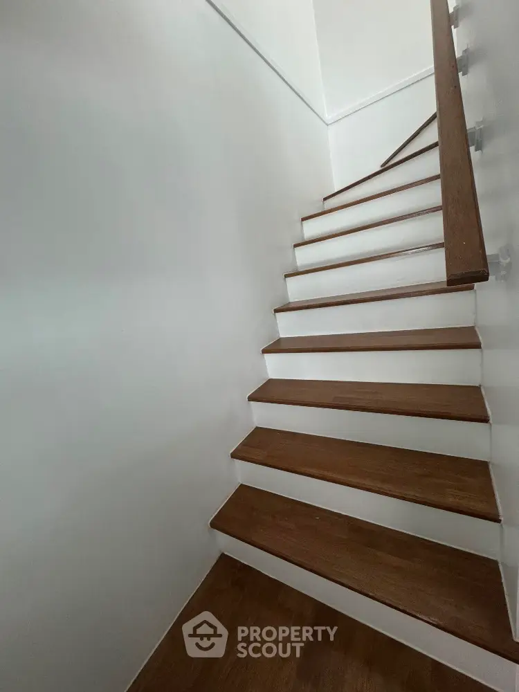 Elegant wooden staircase with modern design in a bright interior space