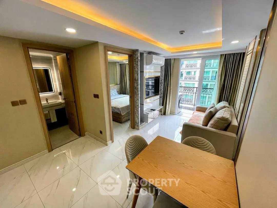 Modern open-plan living room with dining area and bedroom in a stylish apartment