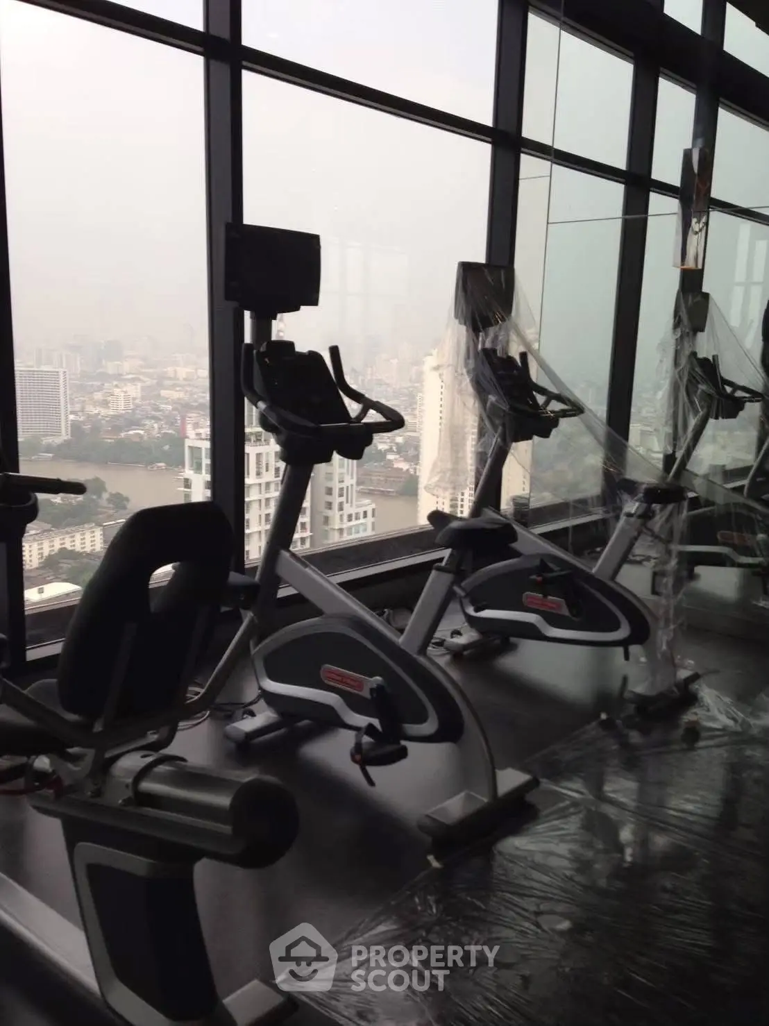 High-rise gym with city view and modern exercise equipment