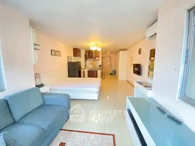 Spacious studio apartment with modern furnishings and open kitchen layout