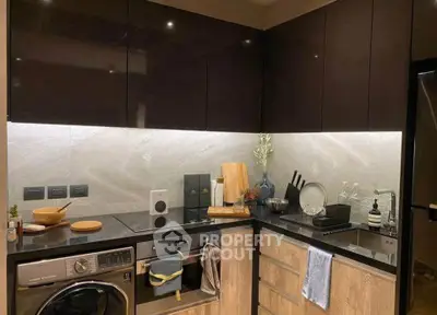 Modern kitchen with sleek cabinets, integrated appliances, and stylish lighting