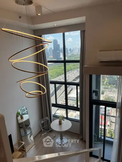 Modern loft with stunning city view and stylish lighting fixture
