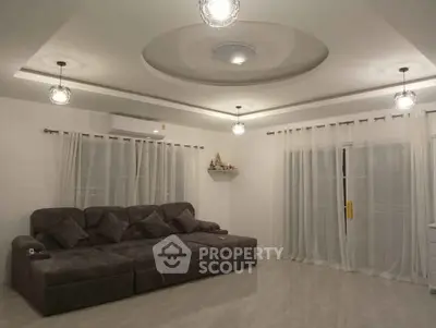 Spacious modern living room with elegant lighting and large sofa.