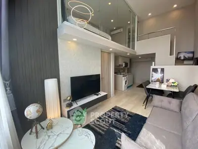 Modern loft apartment with stylish living room and mezzanine bedroom, featuring elegant decor and open layout.