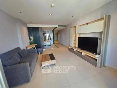 Modern living room with sleek furniture and large TV unit