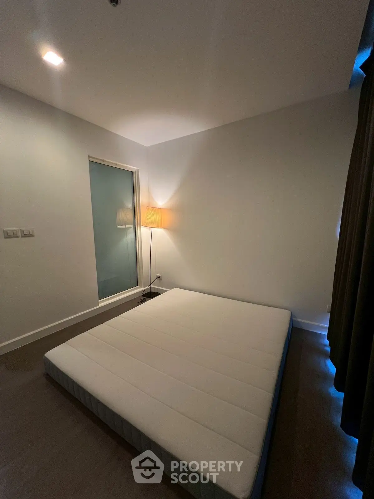 Minimalist bedroom with floor mattress and soft lighting
