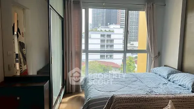 Bright bedroom with large window and modern decor in urban apartment