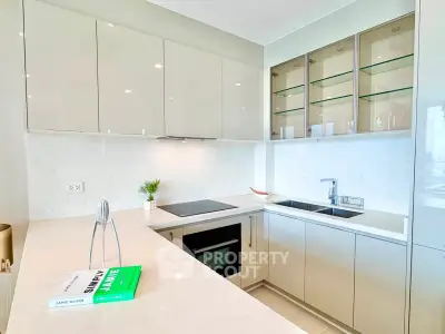 Modern kitchen with sleek cabinetry and built-in appliances, featuring a minimalist design and ample counter space.