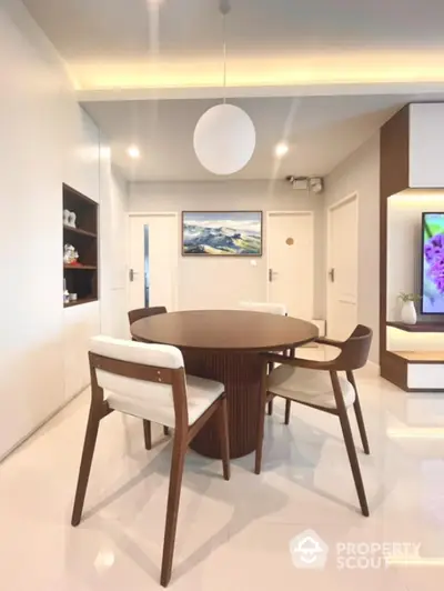 Modern dining area with round table and stylish chairs in a bright interior