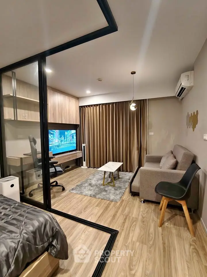 Modern living room with stylish decor, featuring a cozy sofa, sleek TV setup, and elegant wooden flooring.