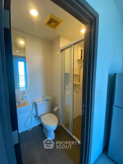 Modern bathroom with shower and toilet in sleek apartment