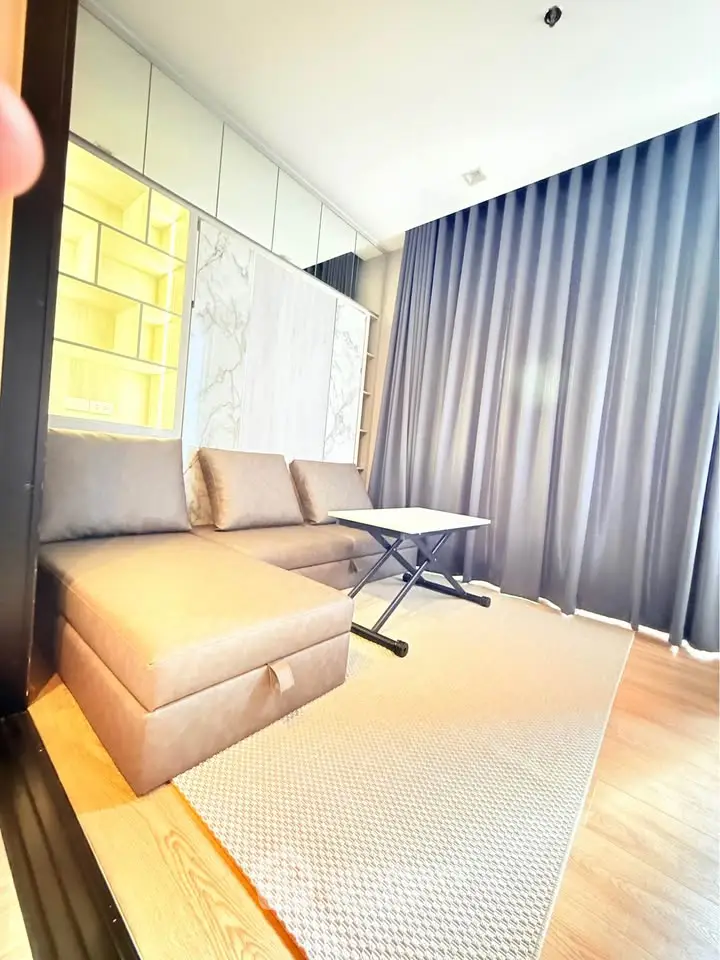 Modern living room with stylish sofa and elegant curtains in a bright apartment.