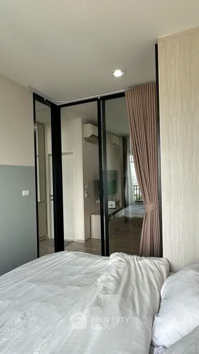 Modern bedroom with sliding glass doors and cozy bedding